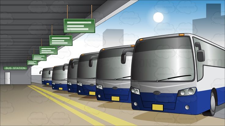 a row of buses parked in a parking garage