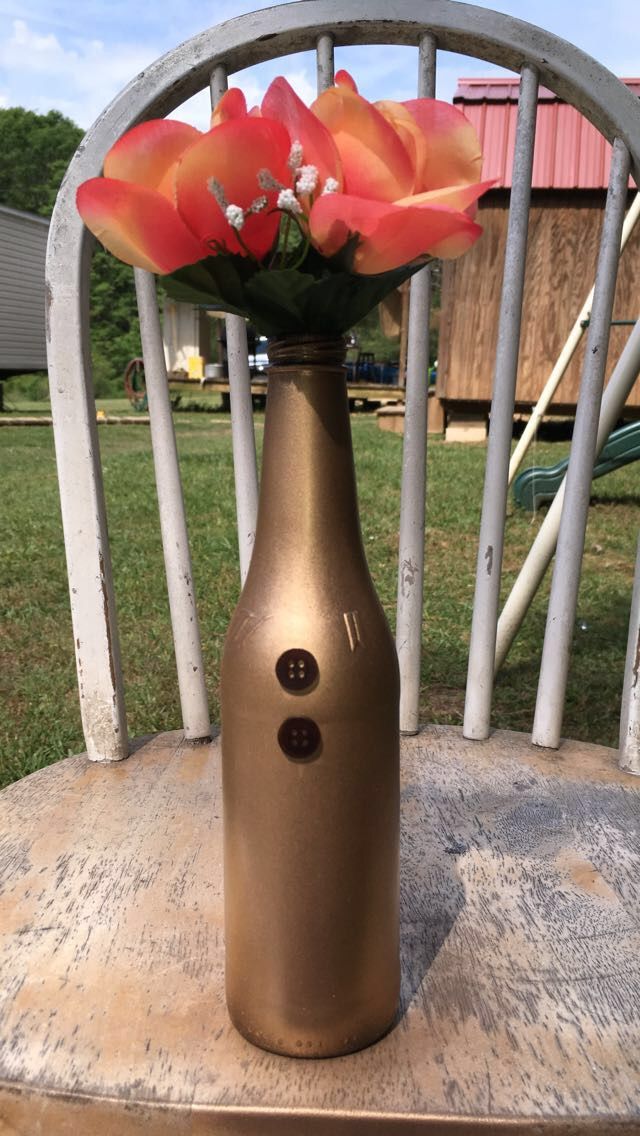 a vase with flowers in it sitting on a chair