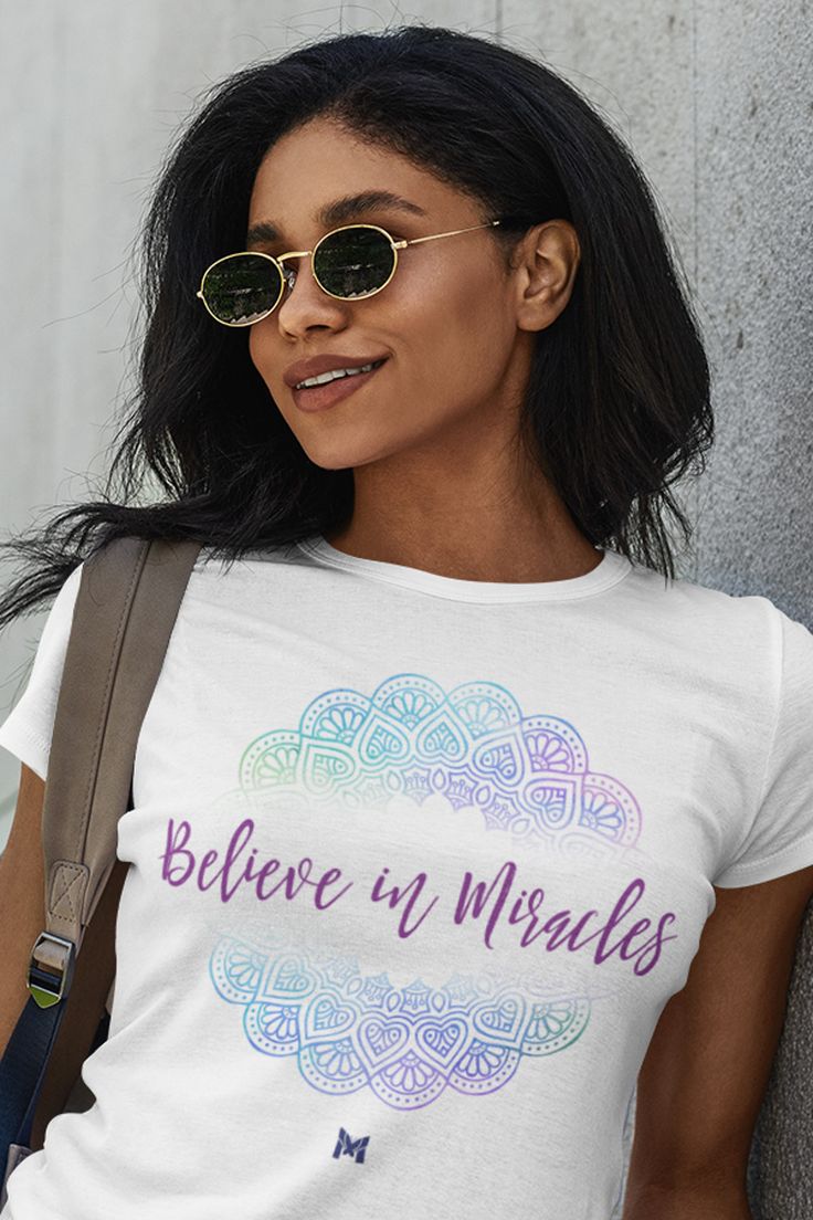 a woman wearing a t - shirt that says believe in miracles