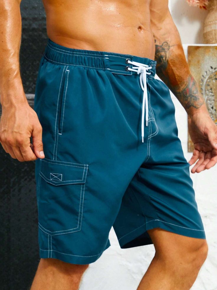 Stay organized and stylish with our Flap Pocket Swim Trunks. These swim trunks feature convenient flap pockets, providing storage for your essentials while on the beach or at the pool. The waistband offers a comfortable fit, and the quick-drying fabric ensures optimal comfort in and out of the water. Features: Color: Blue Pattern Type: Plain Details: Drawstring, Pocket Type: Bottoms Bottom Type: Shorts Fabric: Non-Stretch Care Instructions: Machine wash, do not dry clean Body: Lined Sheer: No Si Nylon Swim Trunks With Side Pockets, Summer Nylon Swim Trunks With Side Pockets, Short Swim Trunks With Pockets, Beach Cargo Shorts For Summer, Blue Shorts With Multiple Pockets For Summer, Nylon Swimwear With Side Pockets, Blue Summer Shorts With Multiple Pockets, Beachwear Nylon Bottoms With Side Pockets, Nylon Beachwear Bottoms With Side Pockets