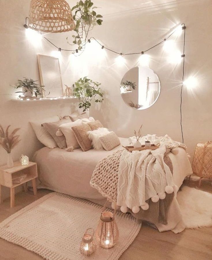 a bedroom decorated with lights and blankets on the bed, rugs in front of it