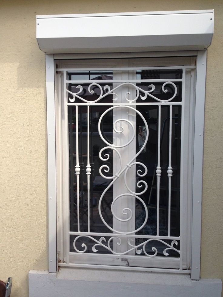 a white window with an ornamental design on it