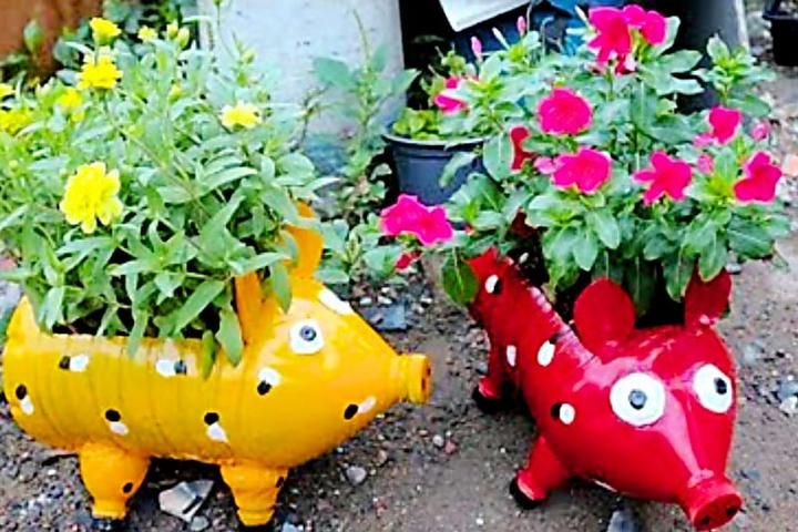 two planters that have flowers in them and one is shaped like a rhinoceros