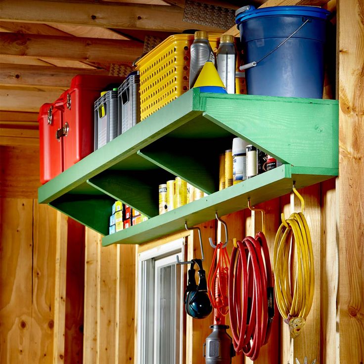 the shelves are filled with various tools and other things to use in this garage storage area