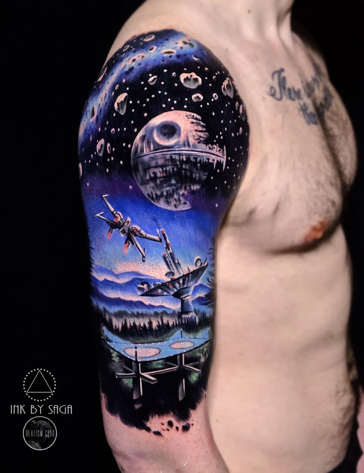 a man with a tattoo on his arm that has an image of spaceships flying in the sky