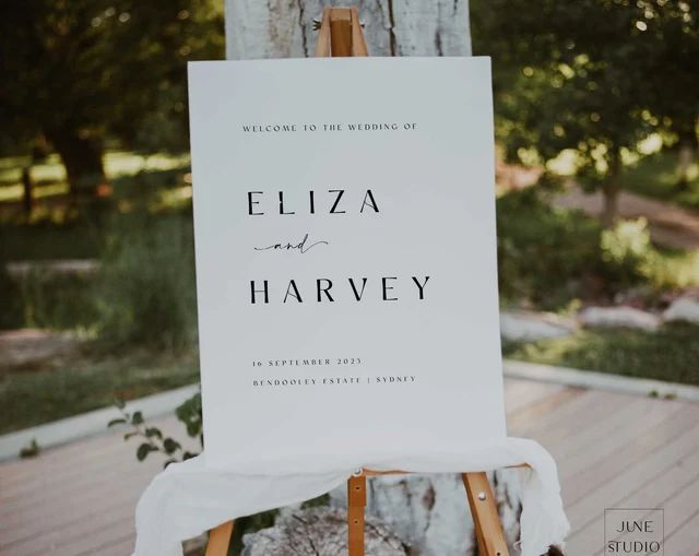 an easel with a sign that says, welcome to the wedding of eliza and harvey