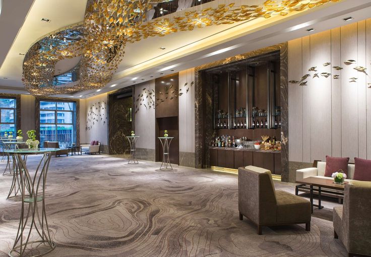 an elegant lobby with marble flooring and chandelier hanging from the ceiling above