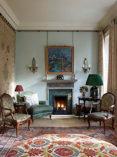 a living room filled with furniture and a fire place in the middle of a room