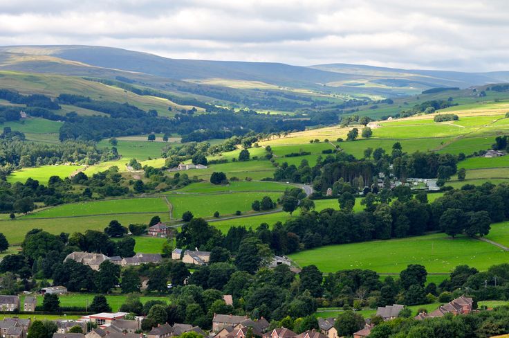 an aerial view of the countryside with houses and trees