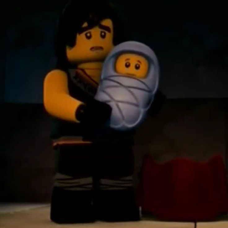 the lego movie character is holding a baby