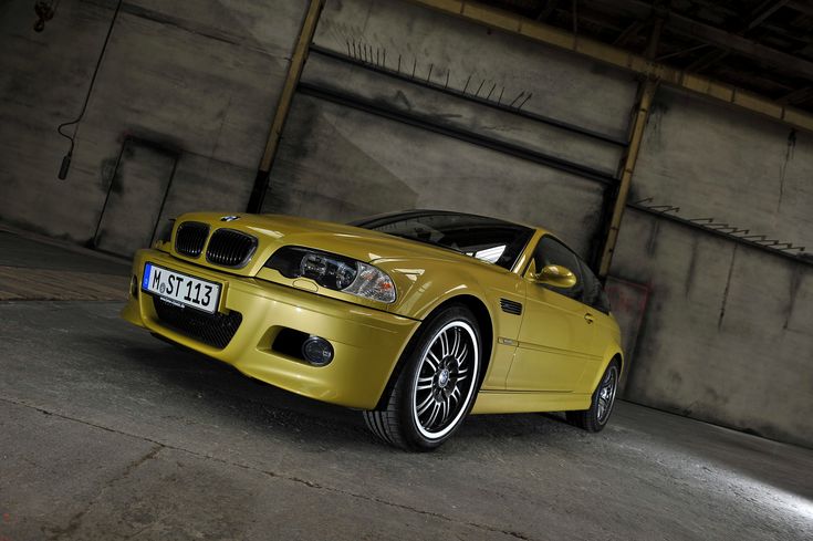 a yellow car is parked in an empty garage