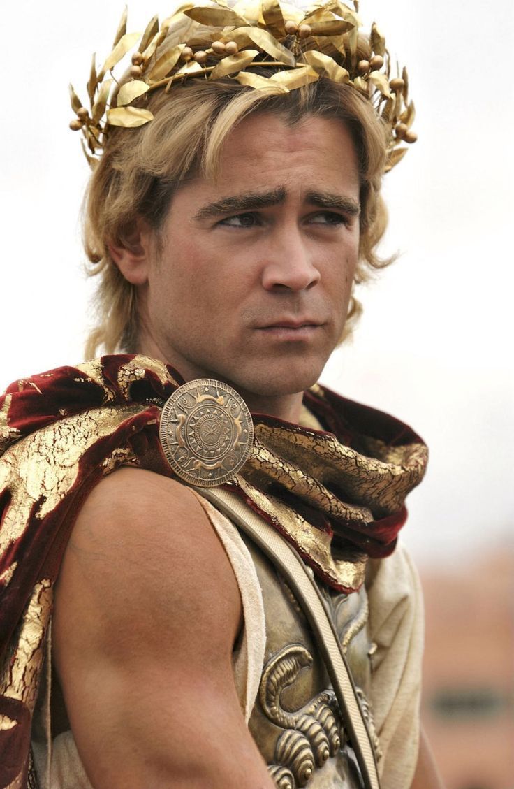 a man dressed in roman clothing with a crown on his head and gold jewelry around his neck