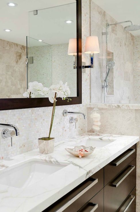 a bathroom with two sinks and a large mirror