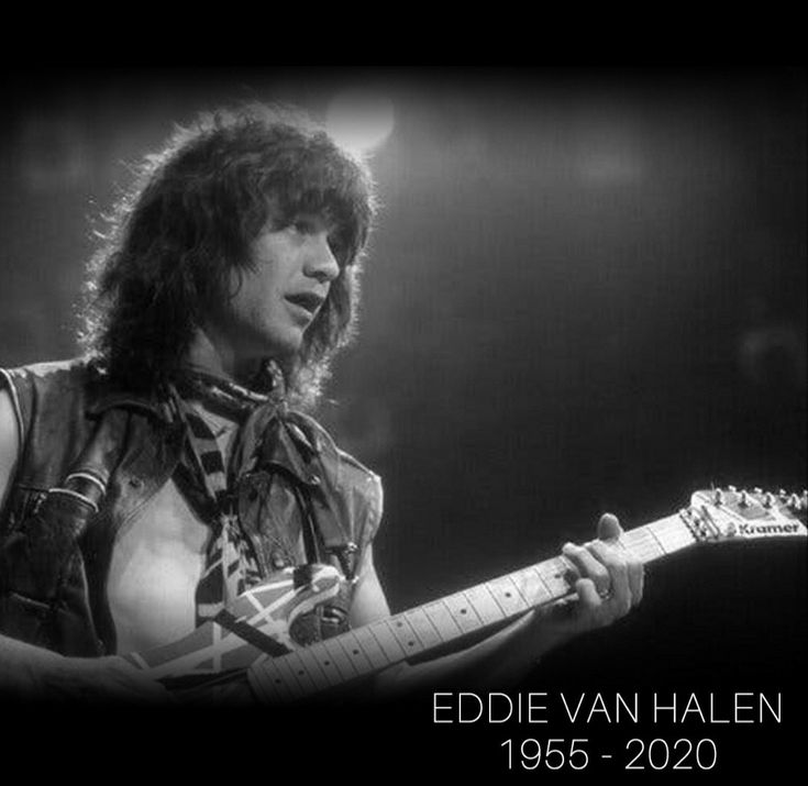 a man with long hair playing an electric guitar in front of a black and white background