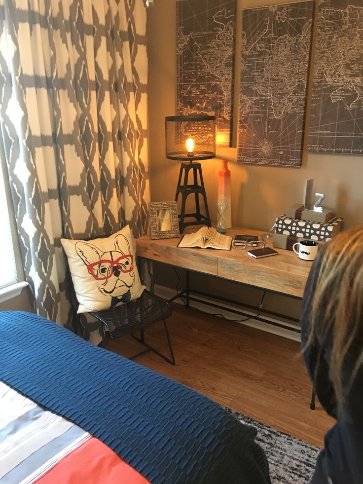 a bed room with a neatly made bed and a night stand next to the window