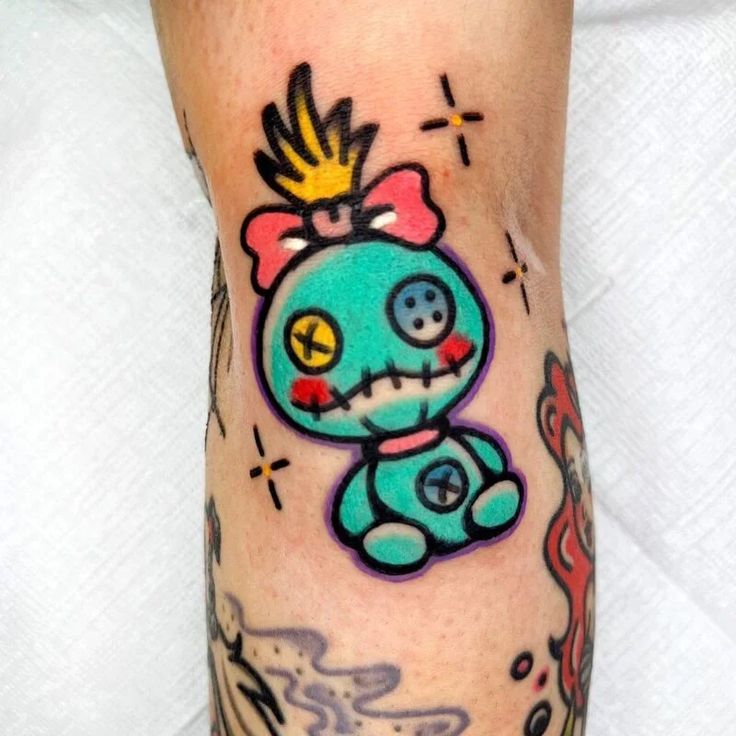 a person with a tattoo on their leg that has an image of a cartoon character on it