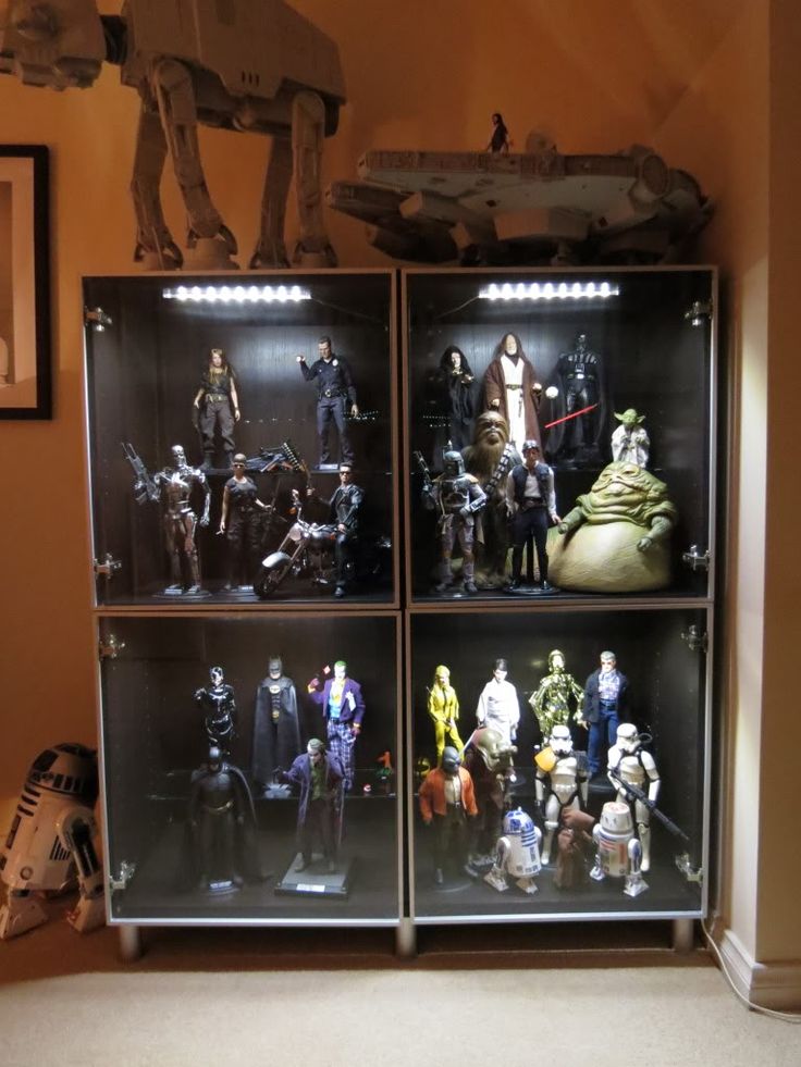 star wars action figures are displayed in glass cases