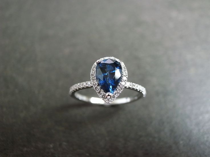 Pear Shaped Blue Sapphire Diamond Ring in White Gold - HN JEWELRY Elegant Sapphire Wedding Ring With Center Stone, Elegant Sapphire Ring With Prong Setting For Proposal, Exquisite Sapphire Gemstone Wedding Ring, Timeless Sapphire Diamond Ring For Weddings, Timeless Sapphire Diamond Wedding Ring, Elegant Round Cut Sapphire Ring For Proposal, Elegant Sapphire Wedding Ring With Prong Setting, Elegant Blue Diamond Ring For Proposal, Elegant Halo Ring For Proposal