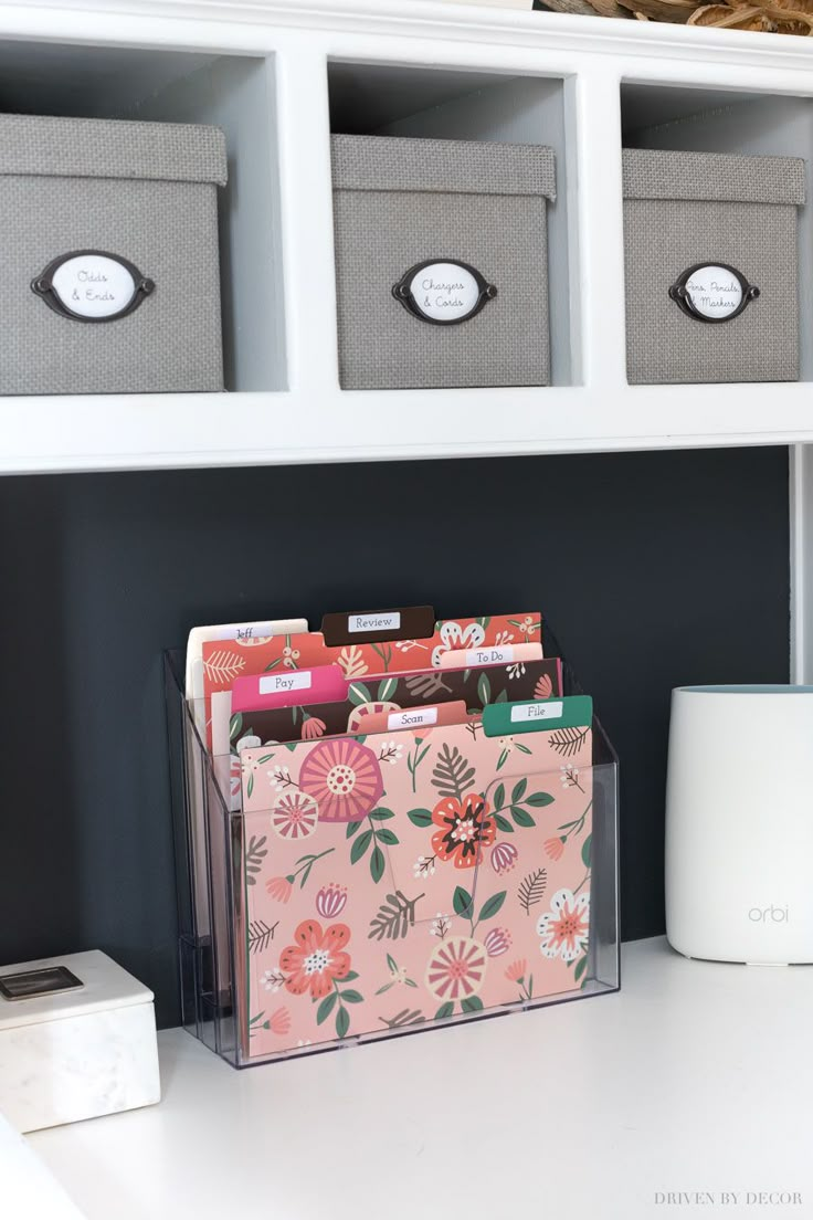 a white desk topped with drawers and bins filled with boxes on top of it