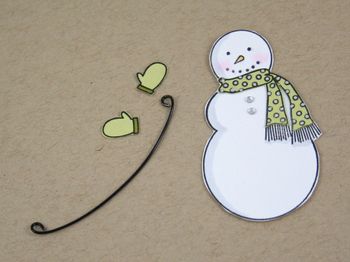 a paper snowman with a green scarf on