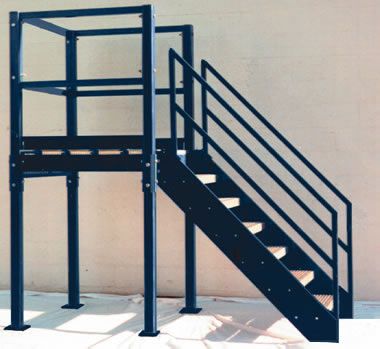 a metal stair case next to a wall