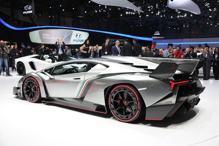 a silver sports car on display at an auto show