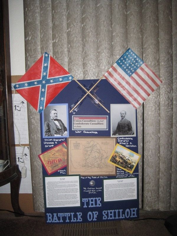 the battle of shiloh is displayed in front of a curtained wall with pictures and flags on it