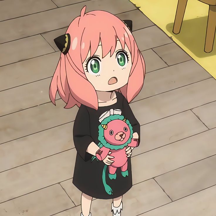 a girl with pink hair and green eyes holding a small pig in her hands while standing on a wooden floor