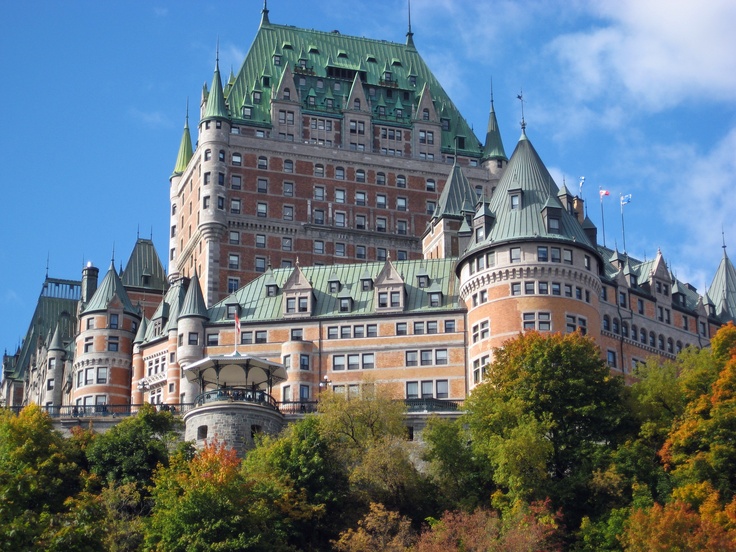 a large building with many windows on top of it's roof and trees around it