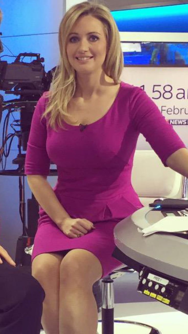 a woman in a pink dress sitting on a chair