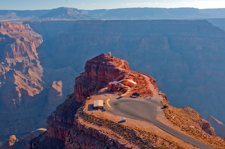 an aerial view of the grand canyon with a truck driving on it's side