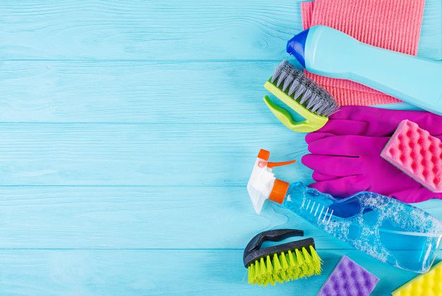 various cleaning products on a blue wooden background