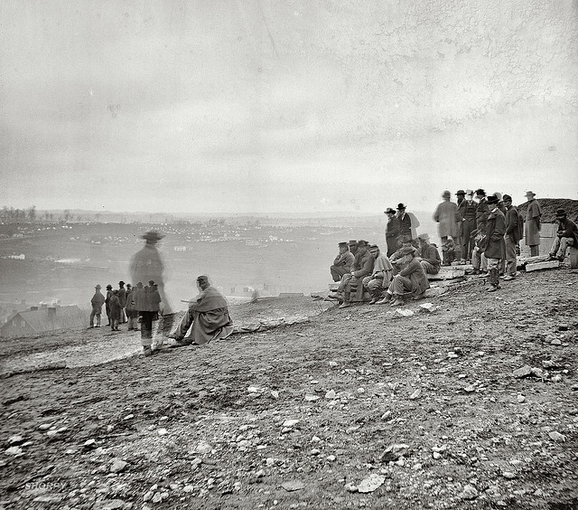 a group of people standing on top of a hill