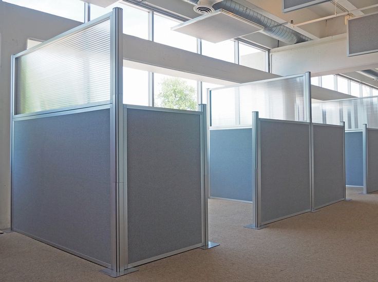 an office cubicle with three partitions in the middle, and several windows on each side