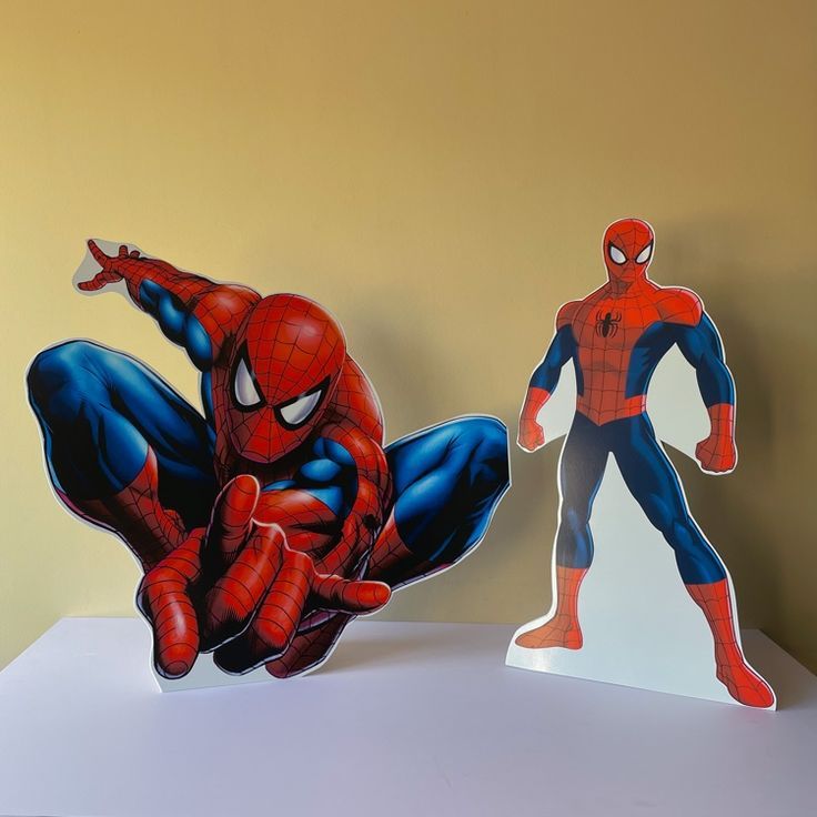 Two Cardboard Cutouts Of Spider - Man Are On Display