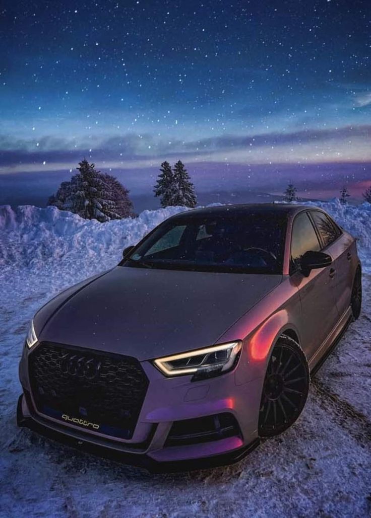 a car parked in the snow at night