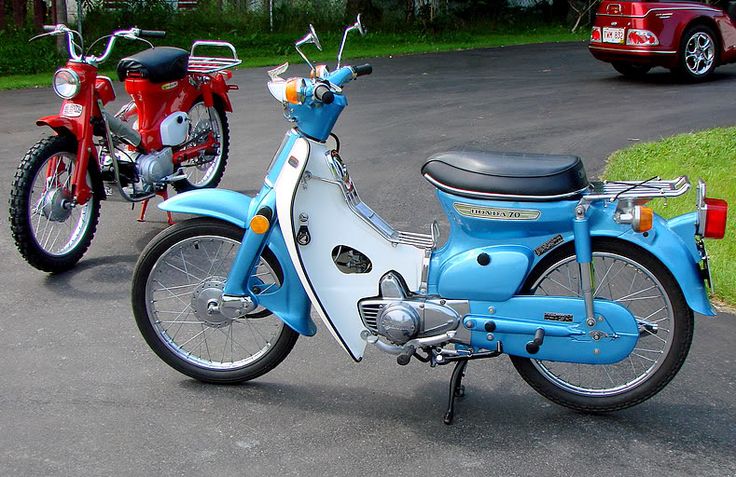 two motorcycles parked next to each other in a parking lot