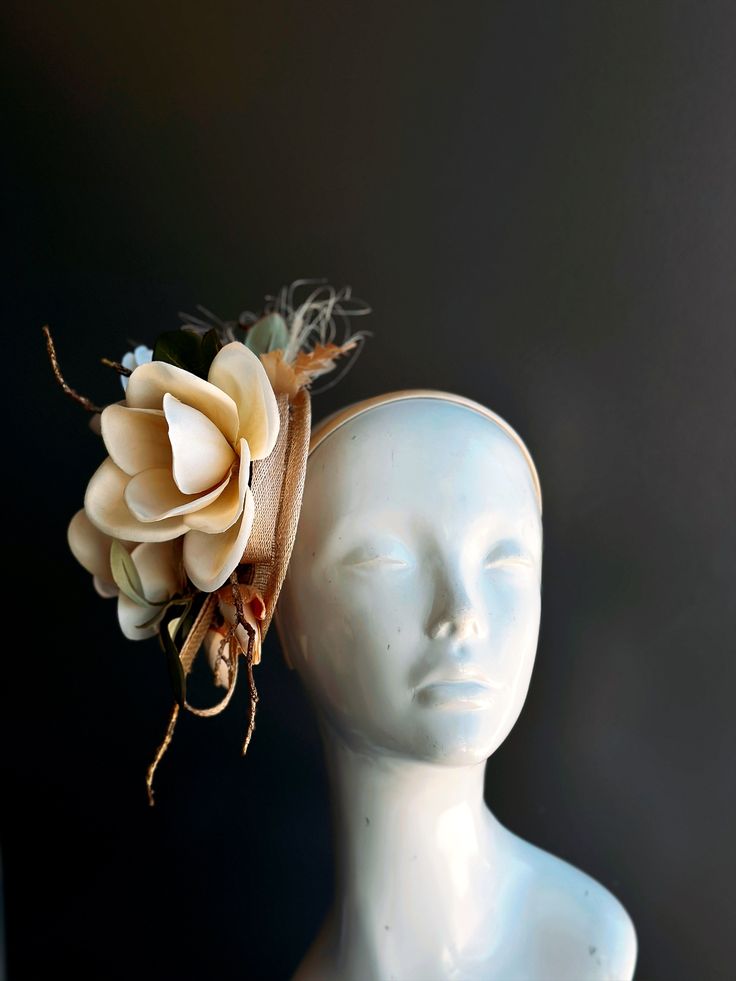 Crafted with intricate precision, the lifelike Magnolia petals and delicate details are a testament to the elegance of this sinamay fascinator hat. Its natural charm and beauty will have you looking like a true Southern belle, perfect for tea parties and Kentucky derby. Age Group/Gender - Adult/Women Size/Type - One size fits all adults Elegant Handmade Headpiece With Structured Crown, Elegant Flower-shaped Hair Accessories With Handmade Flowers, Elegant Flower Hair Accessories With Handmade Flowers, Elegant Handmade Flower Hair Accessories, Elegant Hair Accessories For Spring Ceremonies, Elegant Spring Ceremony Hair Accessories, Whimsical Flower-shaped Fascinator With Handmade Flowers, Whimsical Headpiece For Garden Party, Whimsical Adjustable Headpiece For Garden Party