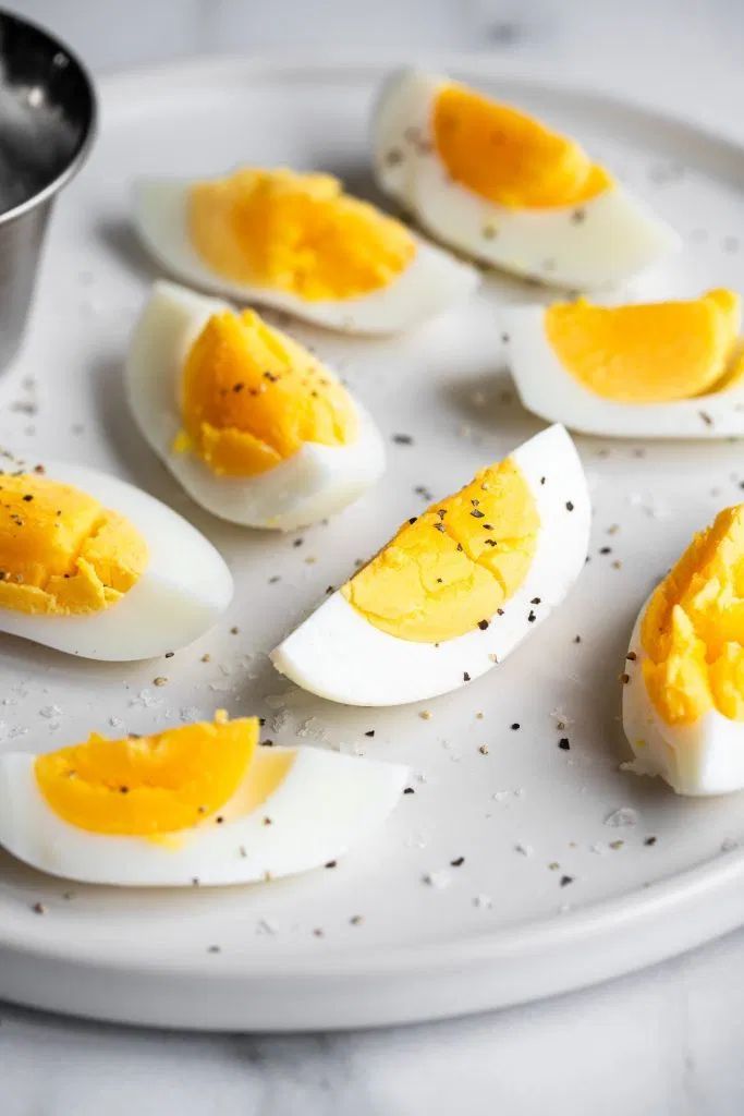 four hard boiled eggs sitting on a plate