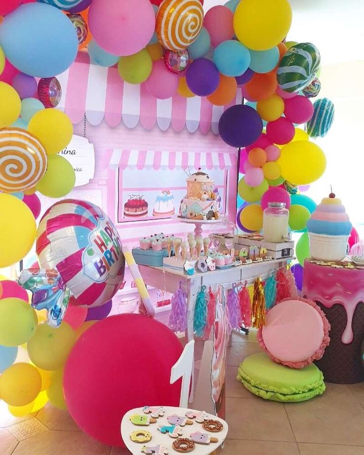 an assortment of colorful balloons and desserts on display