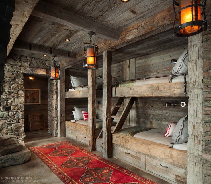 a room with bunk beds and rugs on the floor in front of it,