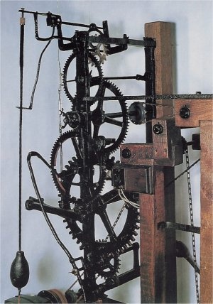 an old clock has gears attached to it