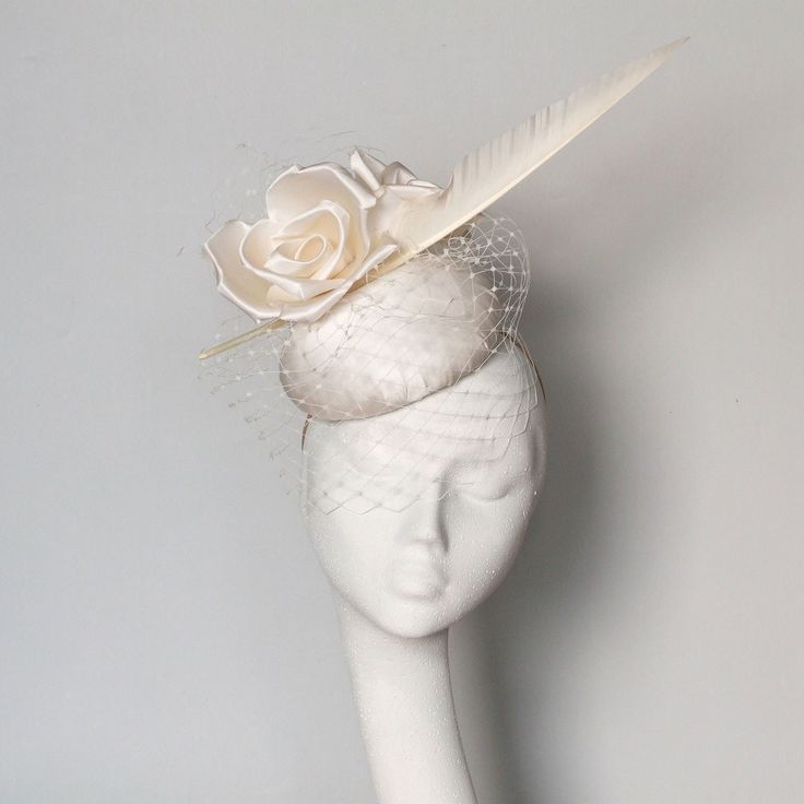 A hand blocked ivory satin silk pillbox fascinator. Beautiful silk flowers,  shaped feather and  veiling. 14 cms diameter fine for Royal Ascot Royal Enclosure. Secured by hat elastic which is easily hidden. This fascinator can be made in  any silk colour contact me with any questions.  Modifications can also be made e.g. different feathers. This item is made to order please allow 1-2 weeks processing. Elegant Cream Fascinator For Vintage Events, Feathered Wedding Fascinator For Royal Ascot, Feathered Fascinator For Wedding At Royal Ascot, Feather Fascinator For Wedding And Royal Ascot, Feathered Mini Hats For Wedding And Kentucky Derby, Elegant Cream Costume Hats For Vintage Events, Feather Fascinator For Wedding At Kentucky Derby, Royal Ascot Wedding Fascinator With Handmade Flowers, Wedding Fascinator With Handmade Flowers For Royal Ascot