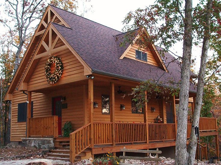 a log cabin with a porch and stairs