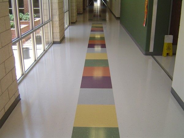 a long hallway with multicolored stripes on the floor