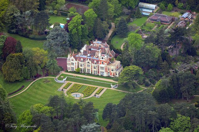 an aerial view of a large mansion surrounded by trees