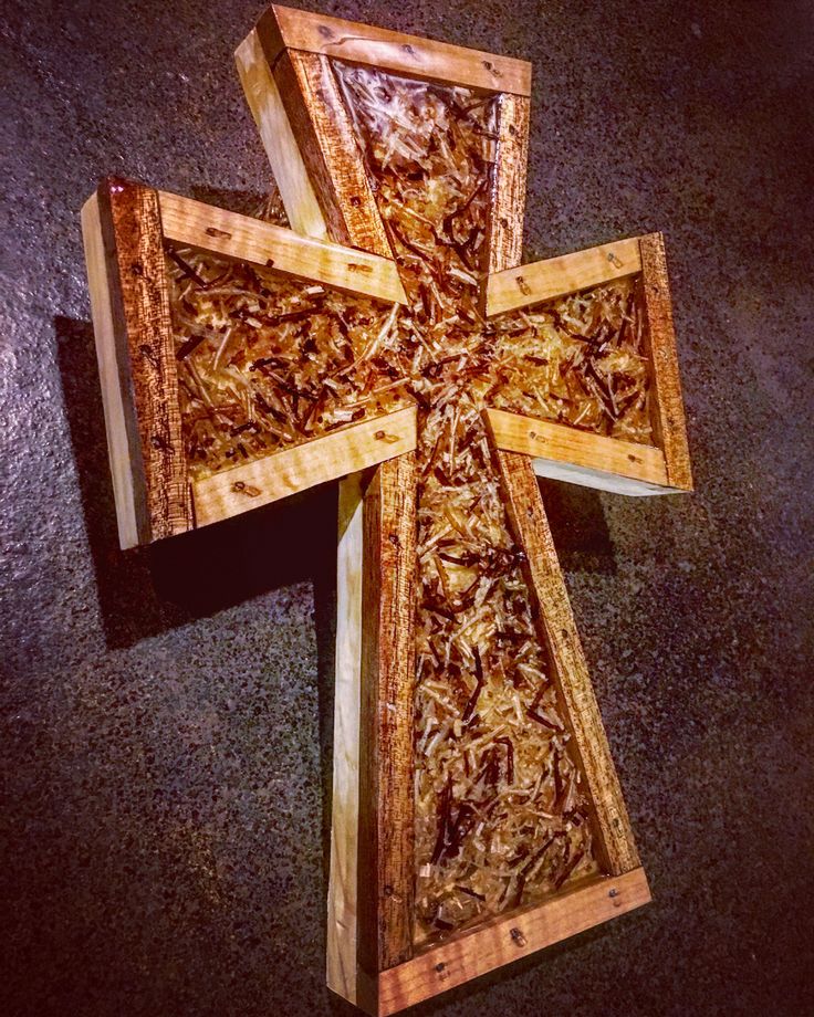 a wooden cross sitting on top of a floor