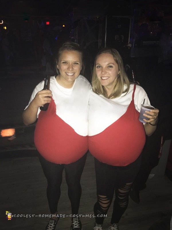 two women dressed in red and white standing next to each other with their butts exposed