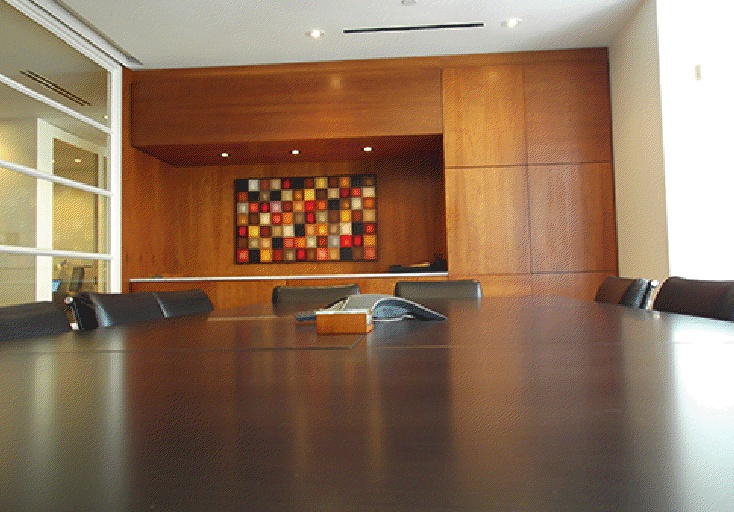 an empty conference room with wooden paneling and leather chairs in front of the table