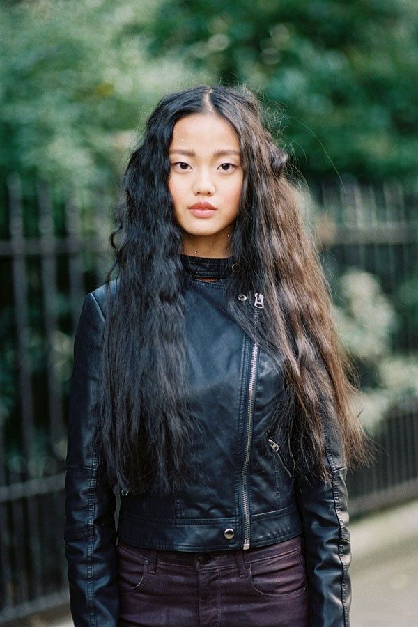 a woman with long hair wearing a black leather jacket